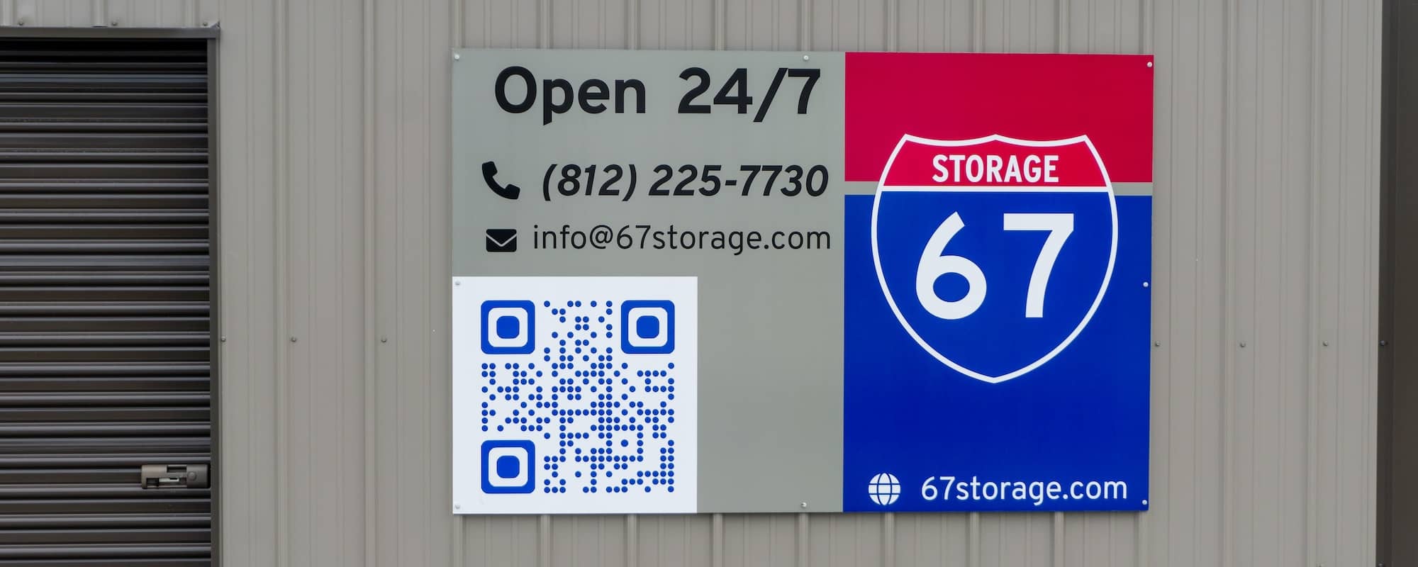 Sign for 67 Storage in Worthington with contact information including phone number, email address, QR code, and website URL, displayed on the brown metal exterior of the storage facility.